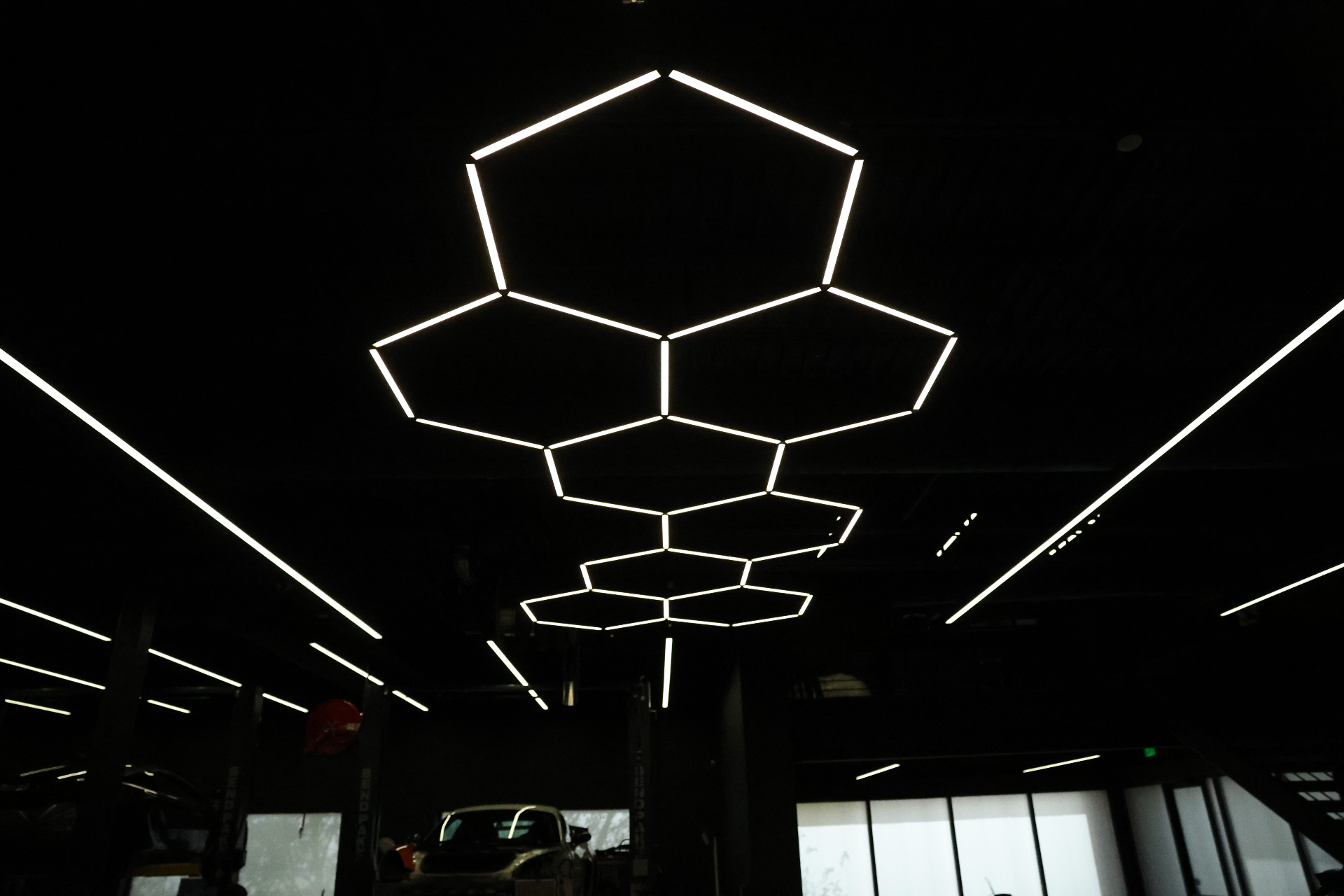 Hexagonal LED ceiling light installation wired by iPowerDenver in a detailing shop